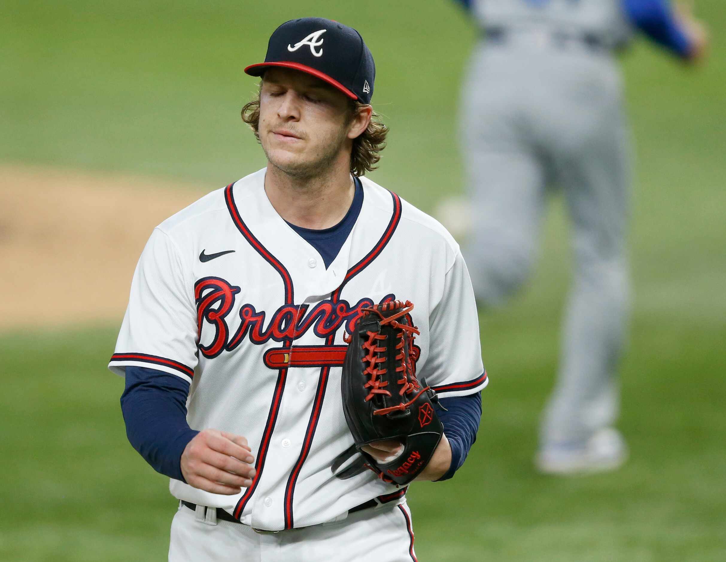 Atlanta Braves relief pitcher Jacob Webb (71) walks back to the dugout after finishing the...