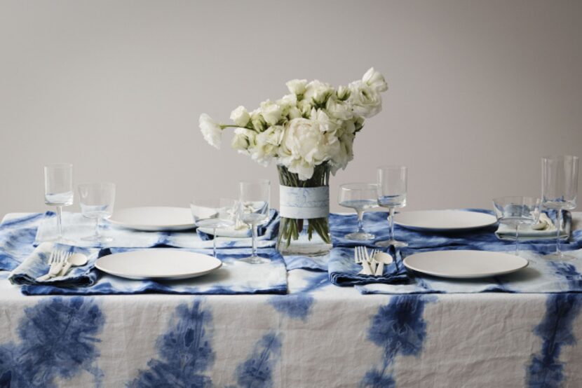 A table set with OriShibori tablecloth, runner, placemats, and napkins