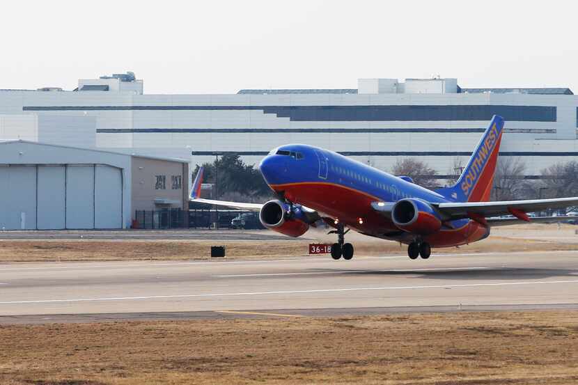 A Southwest Airlines jet takes off in front of corporate headquarters at Dallas Love Field.