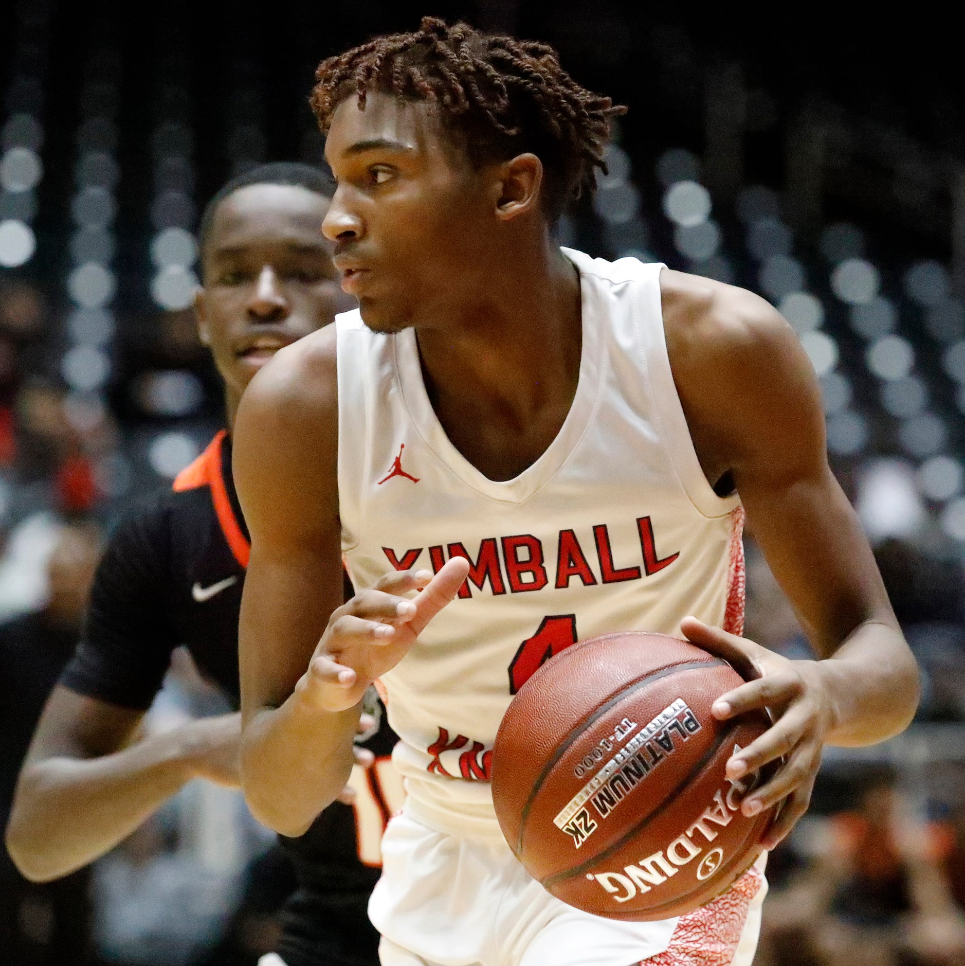 Kimball High School guard Arterio Morris (4) drives in front of Lancaster High School guard...