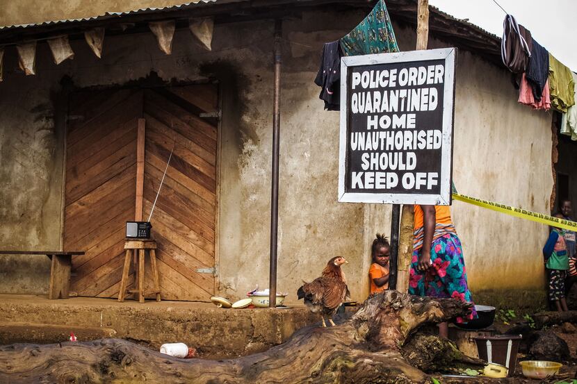 FILE - In this Wednesday, Oct. 22, 2014 file photo, a child stands near a sign advising of a...