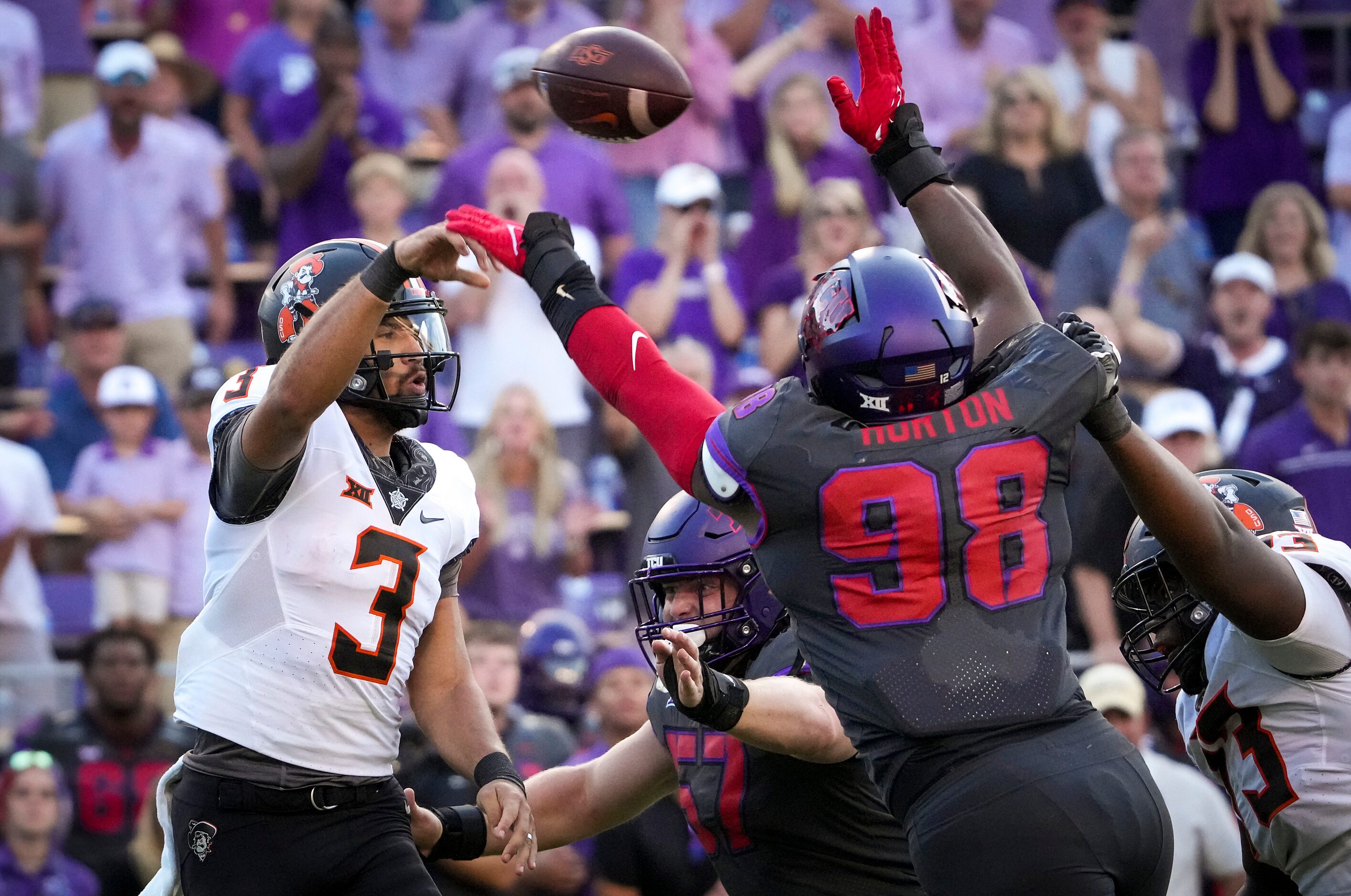 TCU defensive lineman Dylan Horton (98) knocks down a pass by Oklahoma State quarterback...