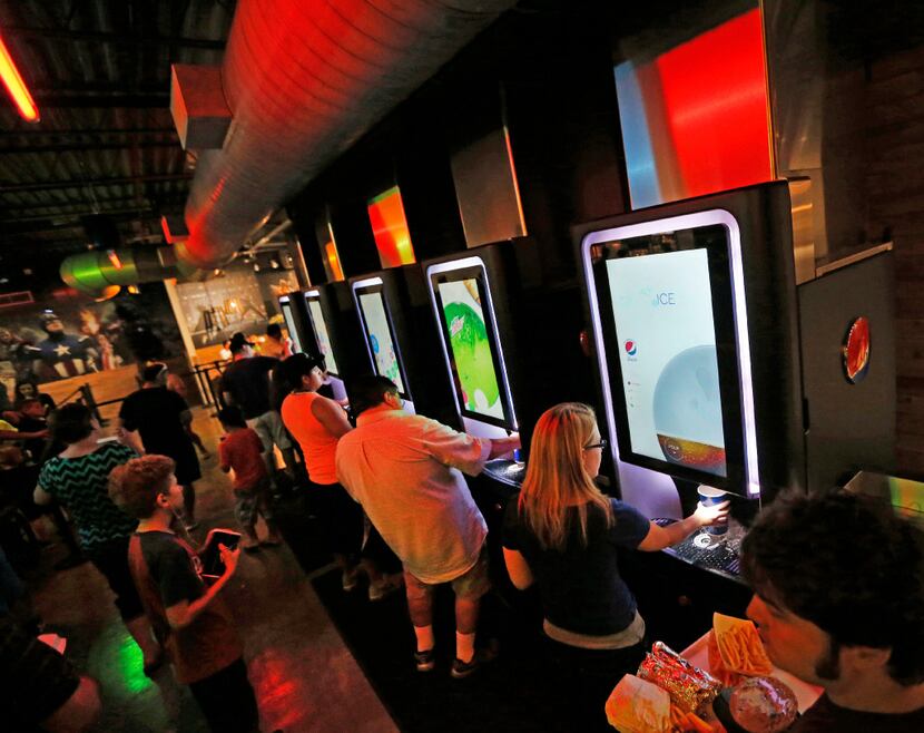 Movie goers use the Pepsi Spire soda fountain machines at the Coyote Drive-In in Lewisville,...