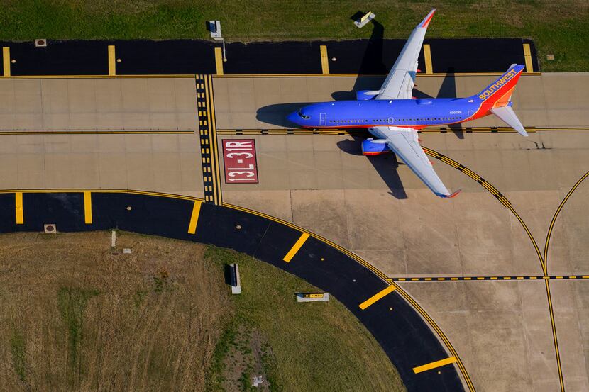 Aerial view of a Southwest Airlines 737-7H4 holding short of the runway at Dallas Love Field...