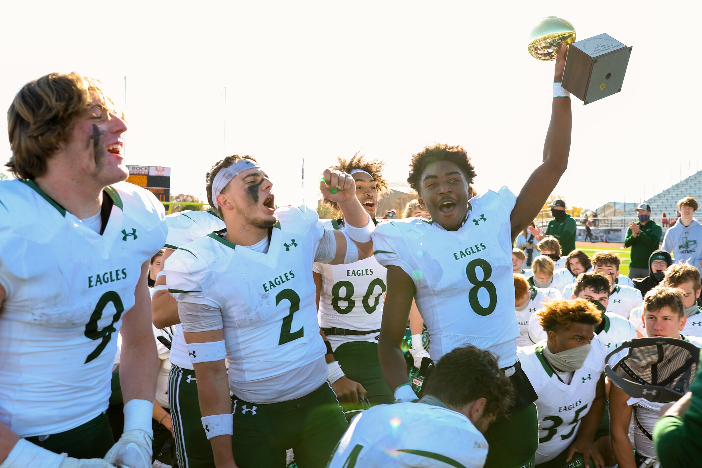Prosper’s Tyler Bailey (8) raises the trophy after a bi-district playoff win against Flower...