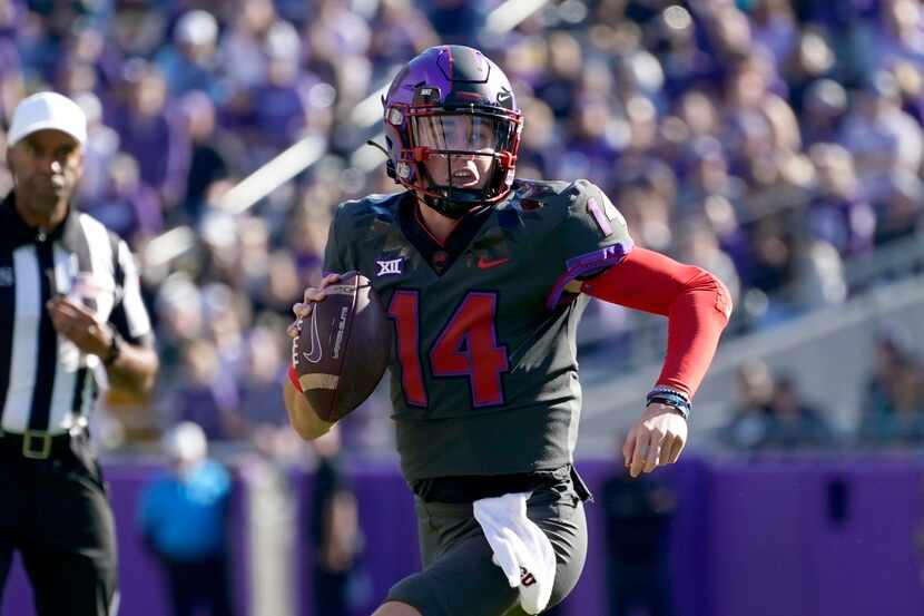 TCU quarterback Chandler Morris (14) scrambles out of the pocket before throwing a pass in...