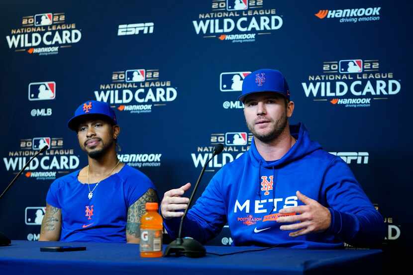 New York Mets' Francisco Lindor, left, listens as Pete Alonso, right, speaks during a news...