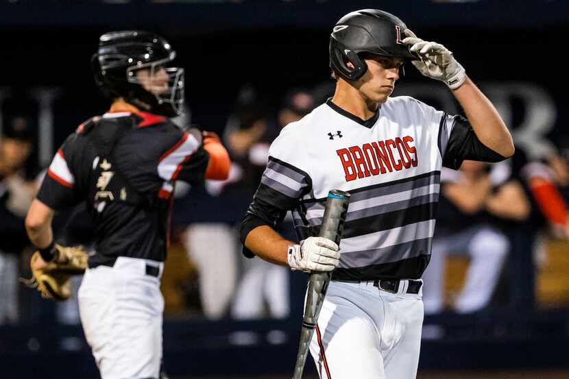 Mansfield Legacy catcher Nate Rombach steps into the batters box during game one of a...