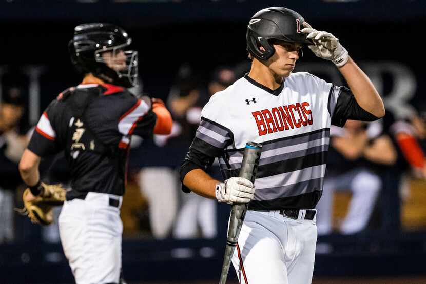 Mansfield Legacy catcher Nate Rombach steps into the batters box during game one of a...