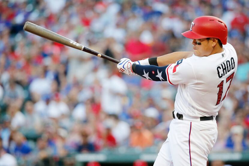 Texas Rangers' Shin-Soo Choo swings for a single during the fourth inning of the team's...
