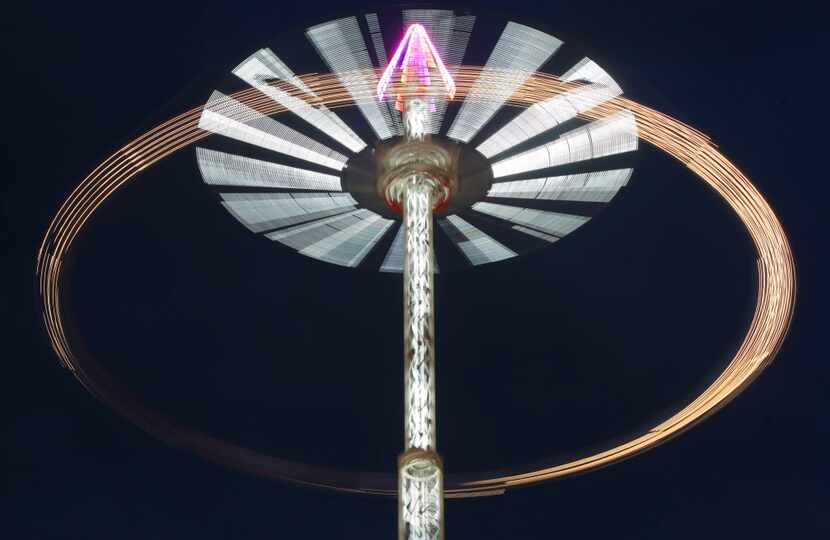 Clouds gather over the Stratosphere swing ride on the Midway during the State Fair of Texas...