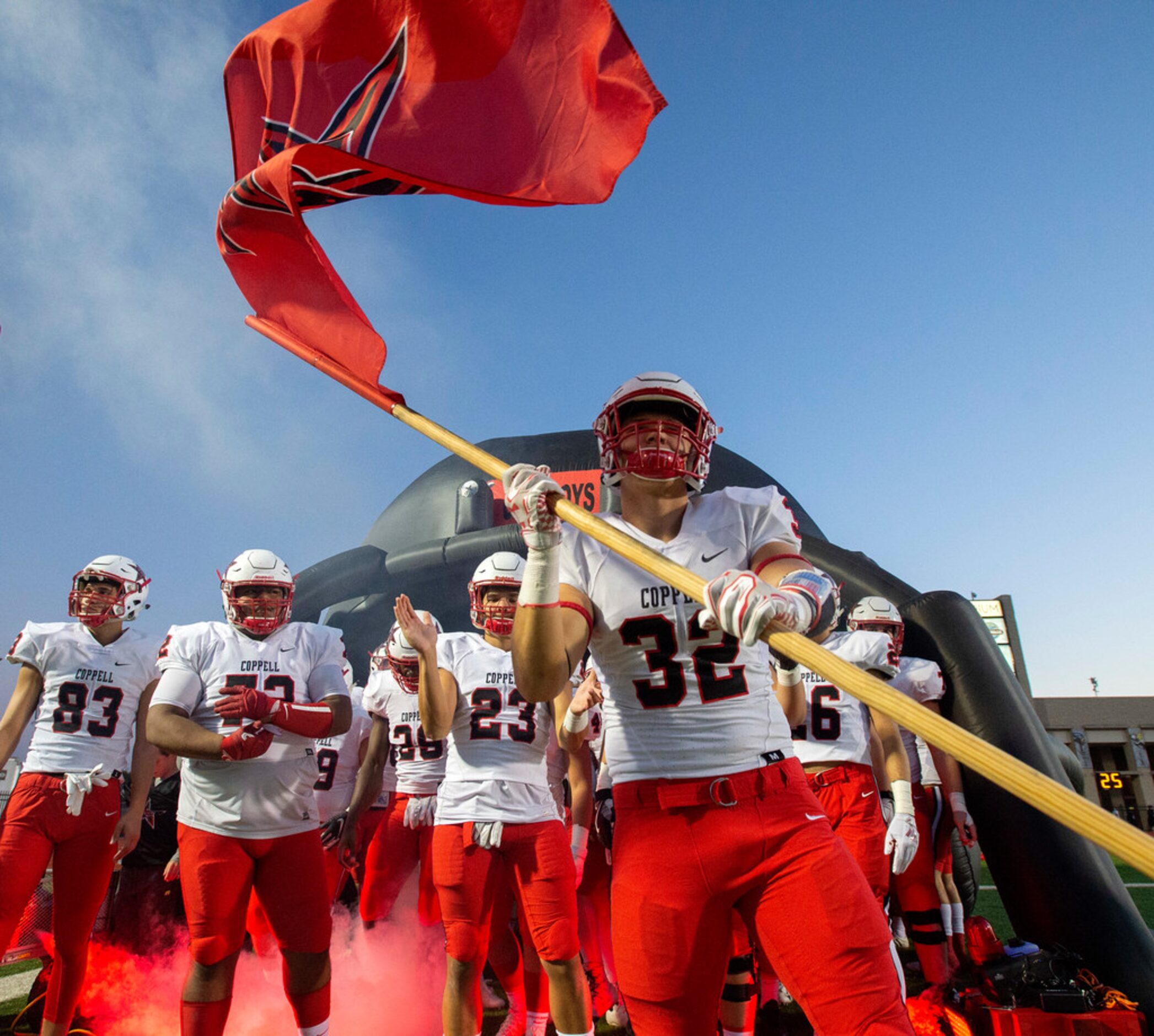 Coppell senior linebacker Joseph Sheddy (32) waves his team's flag before a high school...