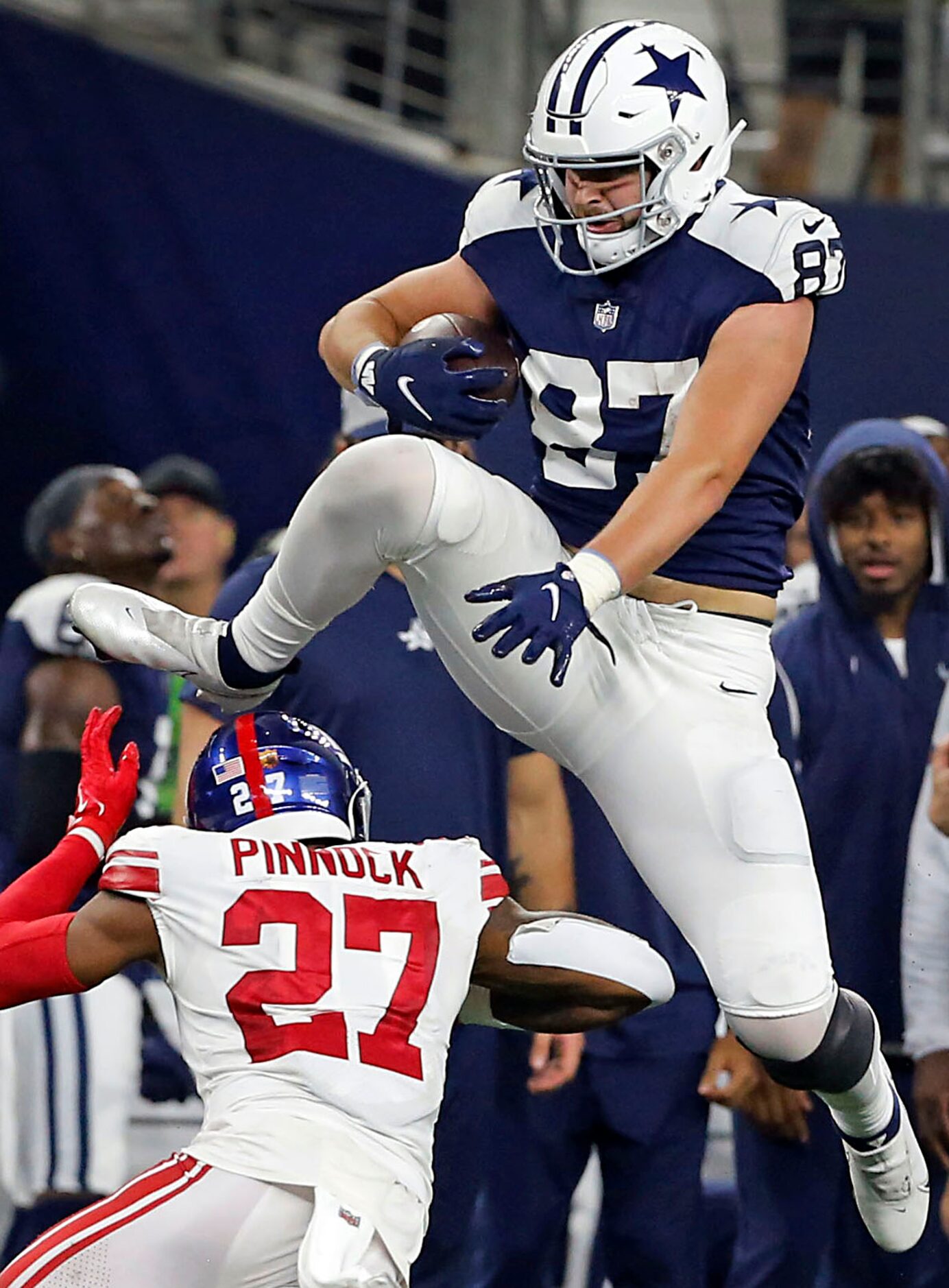 Dallas Cowboys tight end Jake Ferguson (87) leaps high over New York Giants cornerback Jason...