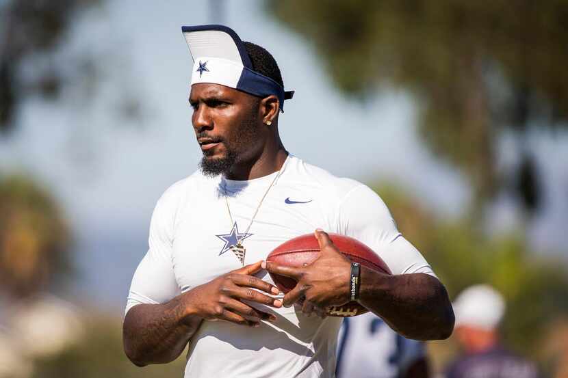 Dallas Cowboys wide receiver Dez Bryant catches passes on the sidelines during the team's...