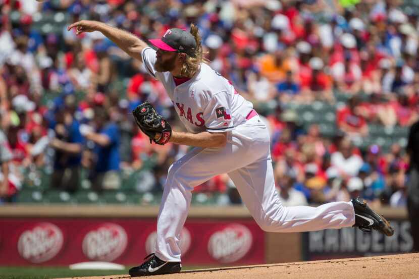 Texas Rangers starting pitcher A.J. Griffin (64) pitches during the first inning of an MLB...