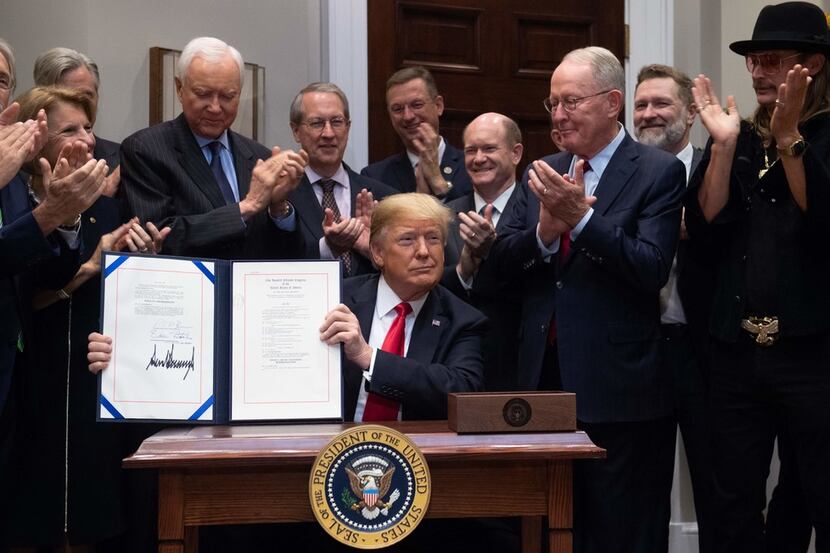 U.S. President Donald Trump, alongside musician Kid Rock (second from right) and members of...