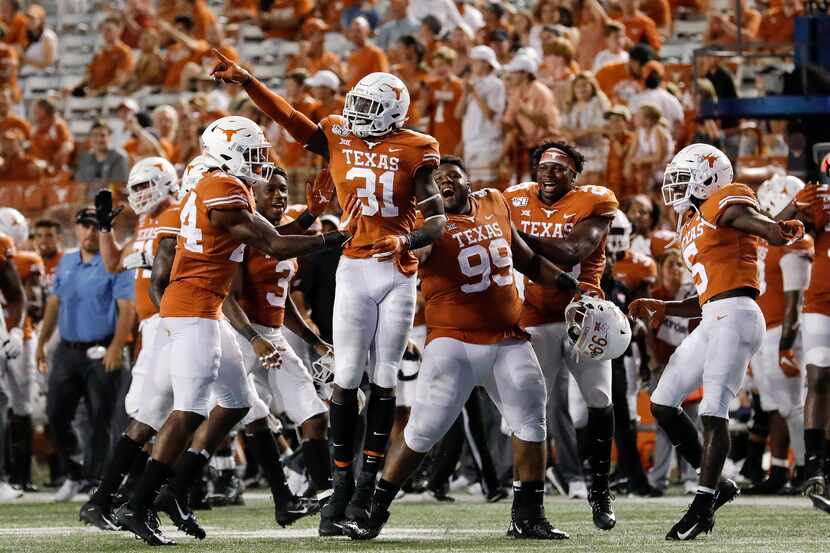 FILE - DeMarvion Overshown (31) of Texas celebrates with teammates after an interception in...