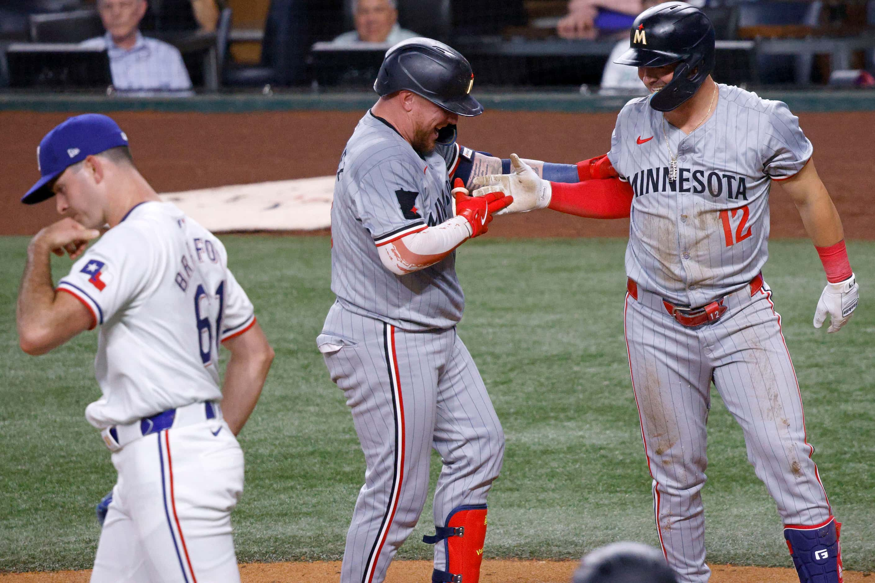 Minnesota Twins second base Kyle Farmer (12), right, celebrates with his teammate Minnesota...