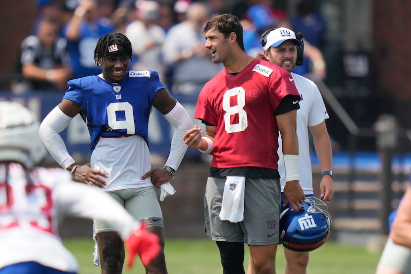 New York Giants quarterback Daniel Jones, right, talks with Malik Nabers during the NFL...