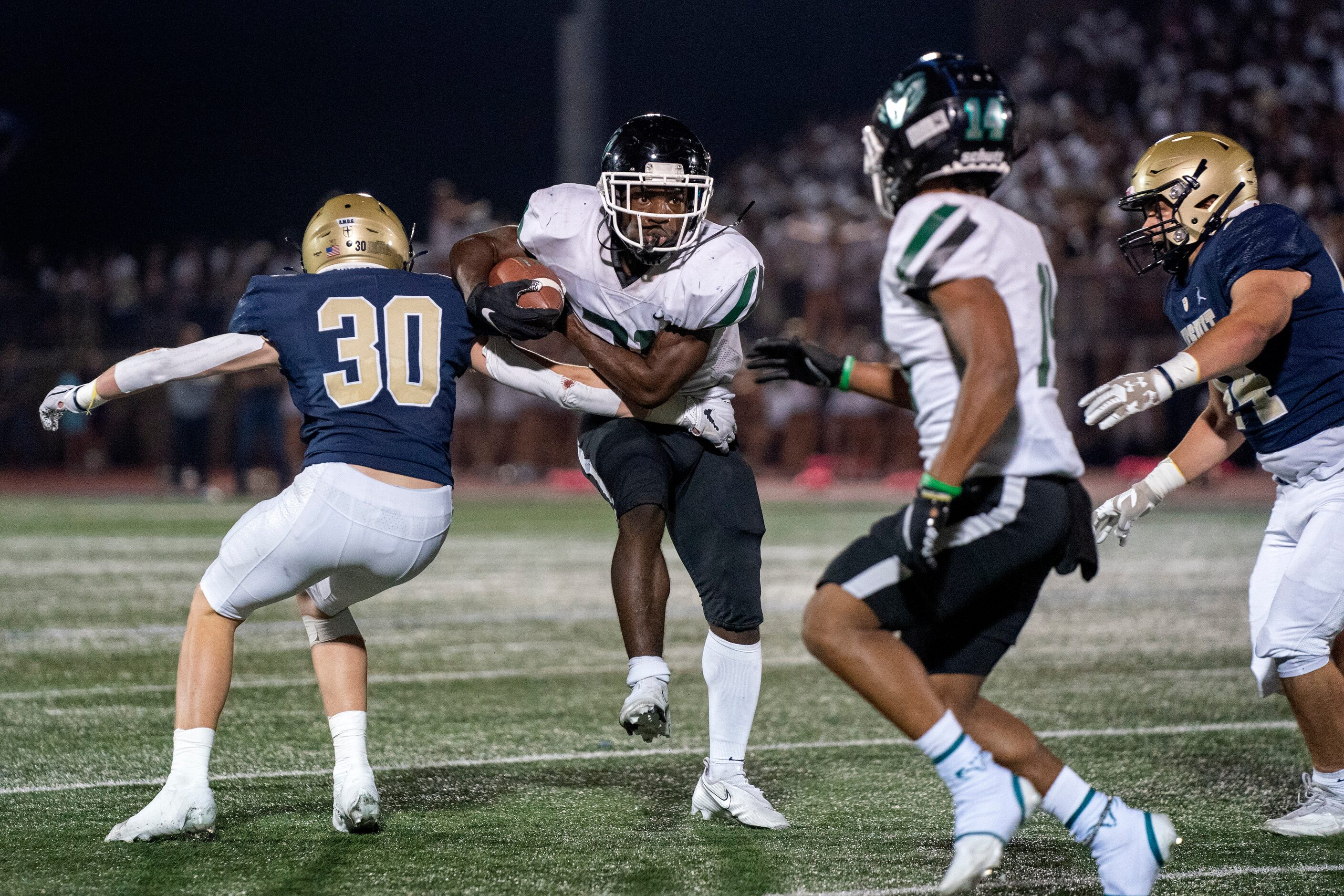 Richardson Berkner senior running back Omarion Barnes (21) tries to break the tackle of...