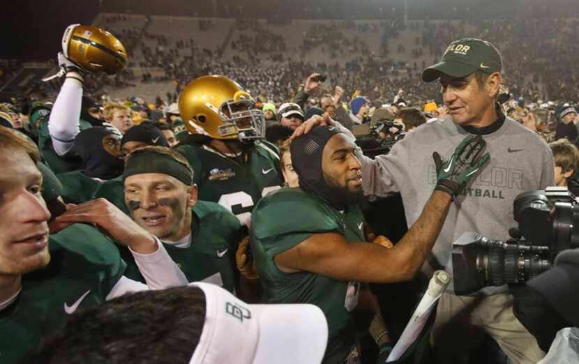  Coach Art Briles shares a moment of affection with safety Ahmad Dixon after the Bears beat...