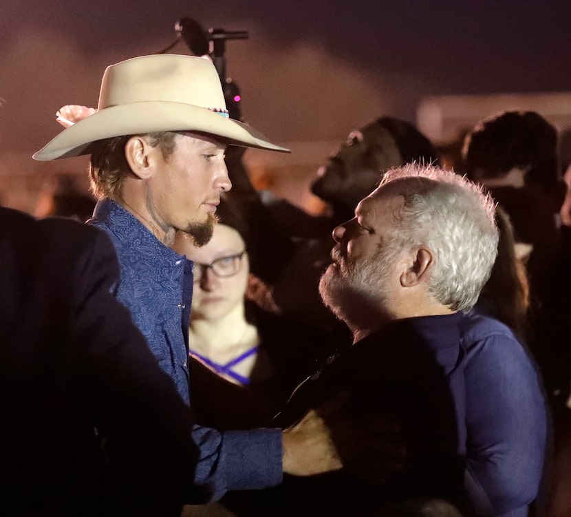 Stephen Willeford (right) hugs Johnnie Langendorff during a vigil for the victims of the...