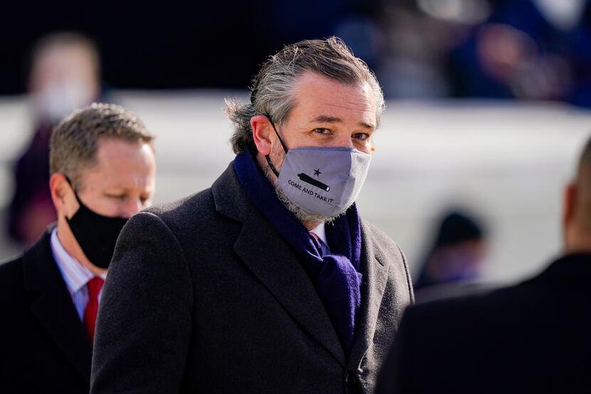 Sen. Ted Cruz, wearing a face mask that reads "Come and Take It," arrives to the...