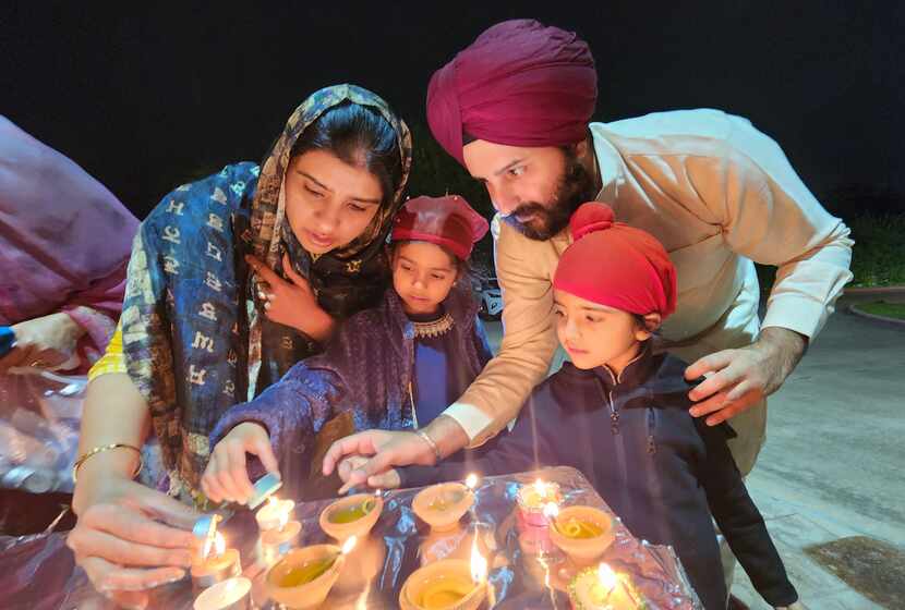Amit Kohli lights diyas with his wife Simar and his children, Gia, 6 and Anhad, 4, at the...