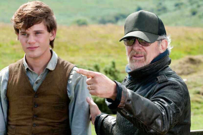 Director Steven Spielberg and actor Jeremy Irvine on the set of "War Horse," an adventure...