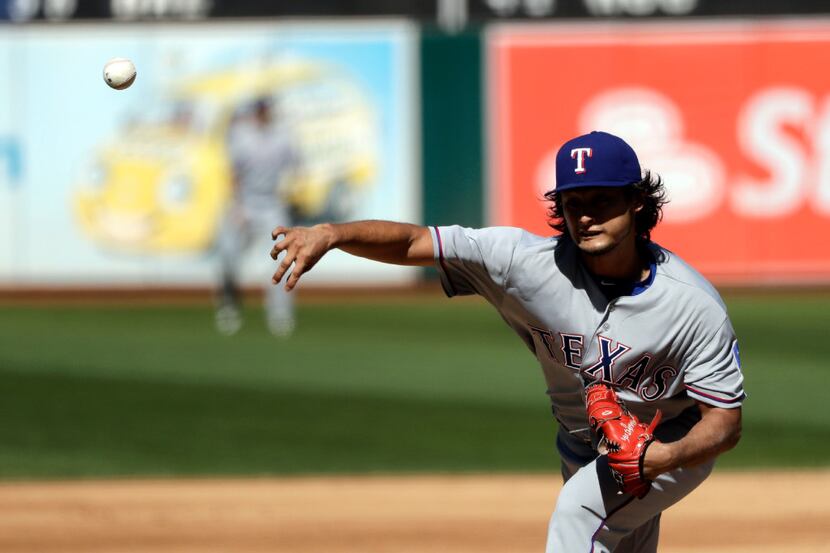Texas Rangers starting pitcher Yu Darvish throws to the Oakland Athletics during the fifth...