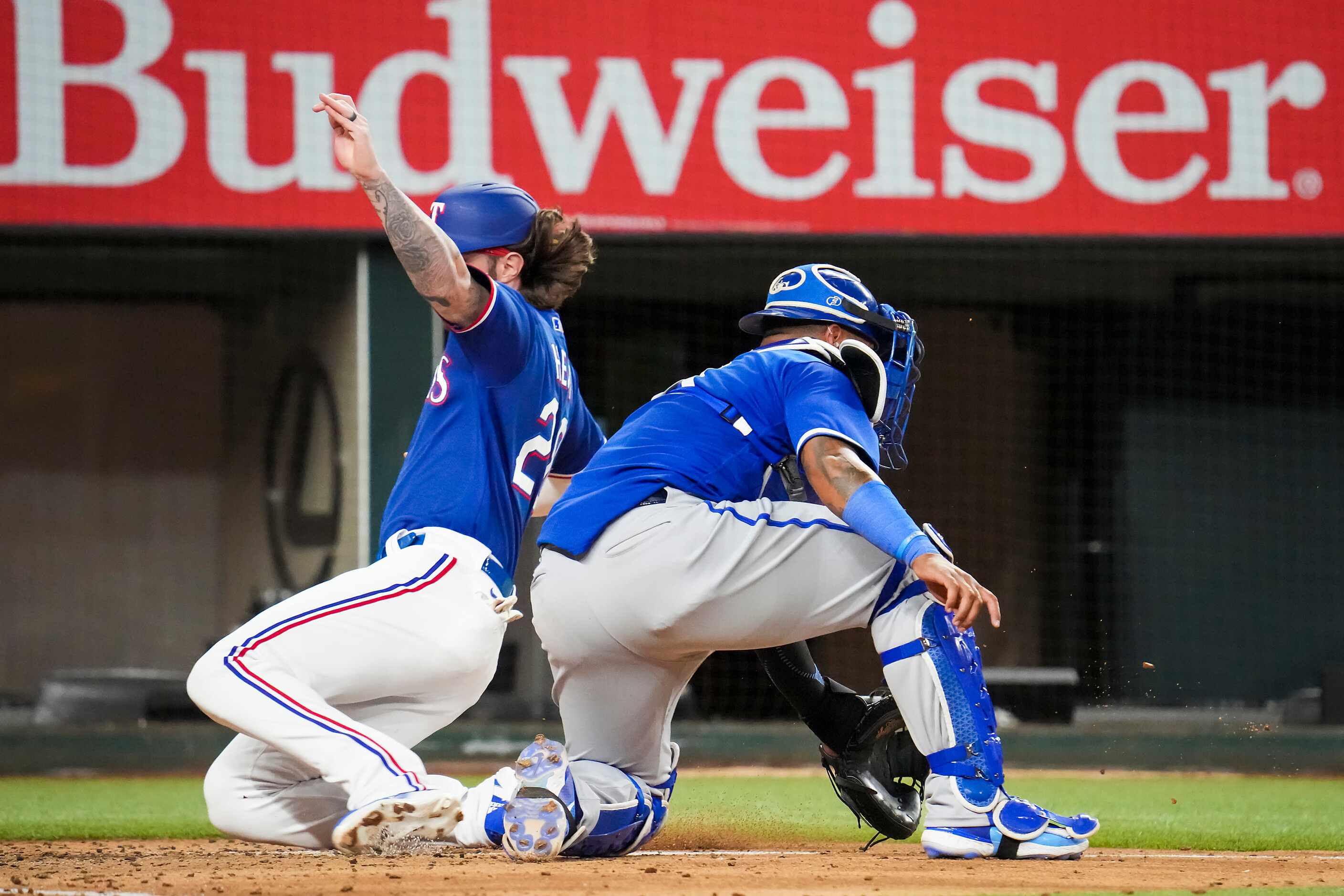 Texas Rangers designated hitter Jonah Heim scores past Kansas City Royals catcher Salvador...