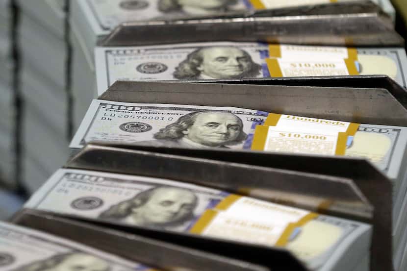Stacks of $100 bills make their way down the line at the Bureau of Engraving and Printing...