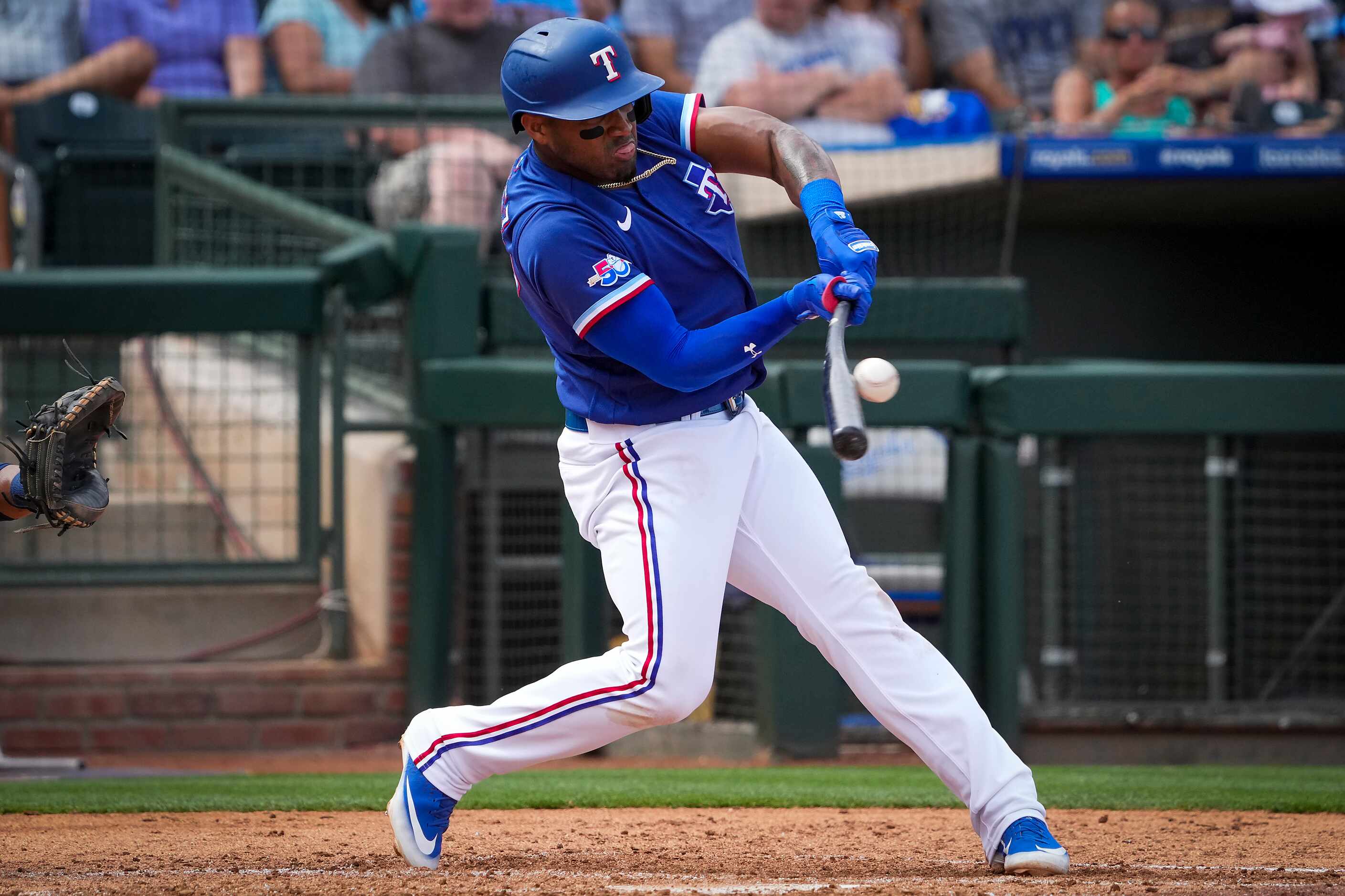 Texas Rangers infielder Andy Ibáñez bats during the fourth inning of a spring training game...