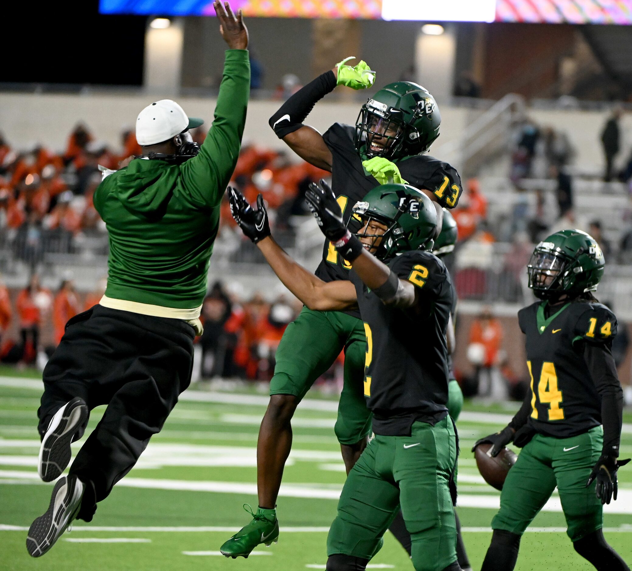 DeSoto’s Johntay Cook II (14) Jaedon Wilson (2) and Robert Richardson (14) celebrate their...