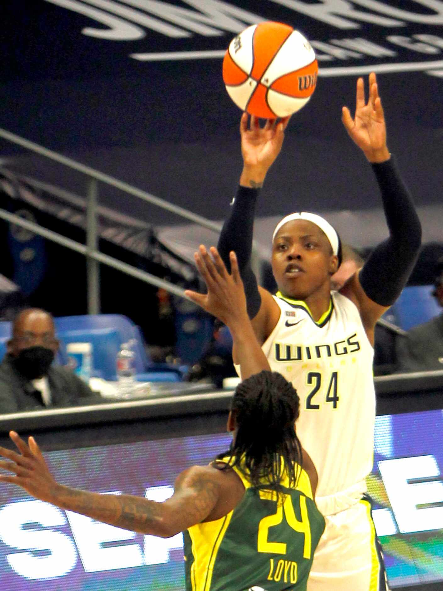 Dallas Wings guard Arike Ogunbowale (24) puts up a jump shot over the defense of Seattle...