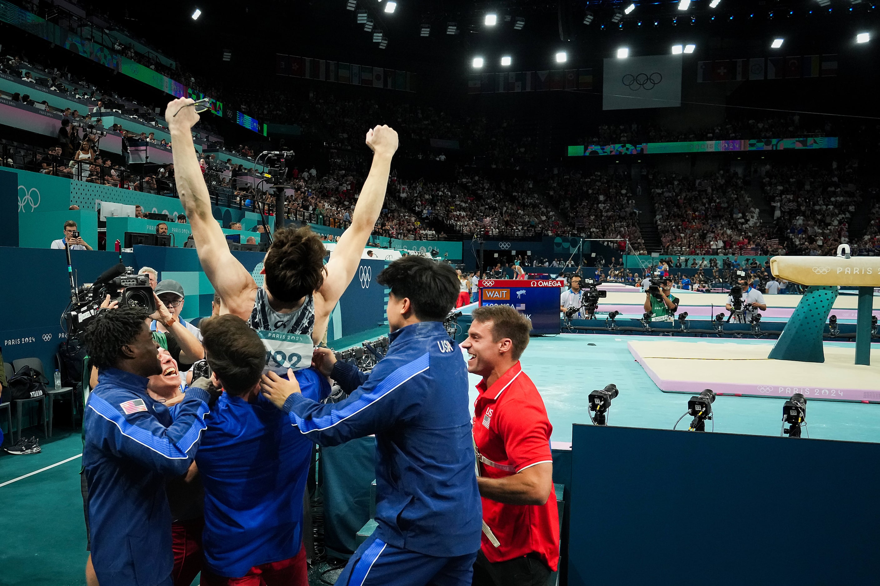 Stephen Nedoroscik of the United States is lifted up by teammates (from right) Frederick...