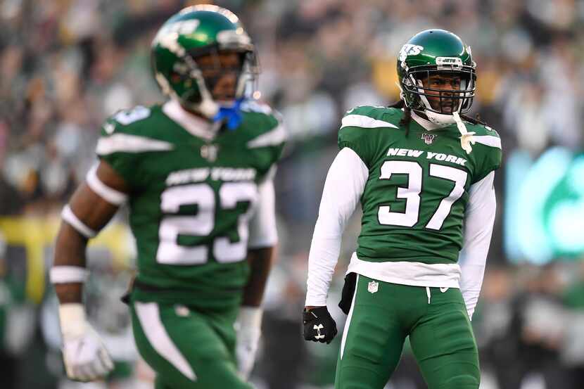 FILE — Maurice Canady #37 of the New York Jets reacts after teammate Marcus Maye (not...