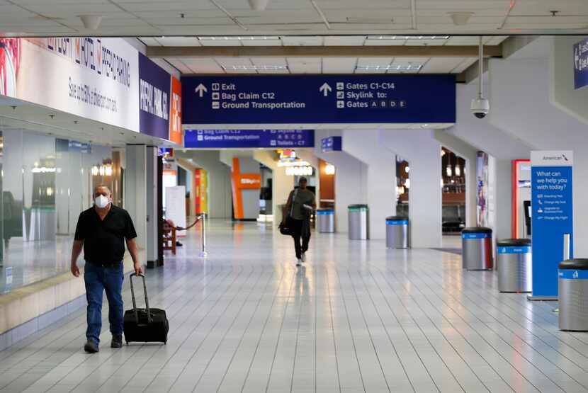 People make their way through terminal C at DFW International Airport on April 8. The...