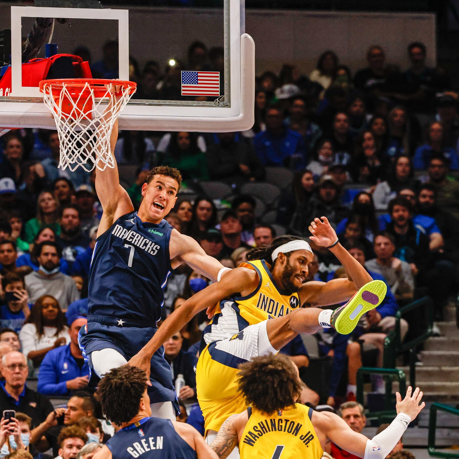 Dallas Mavericks guard Theo Pinson (1) dunks the basketball next to Indiana Pacers forward...