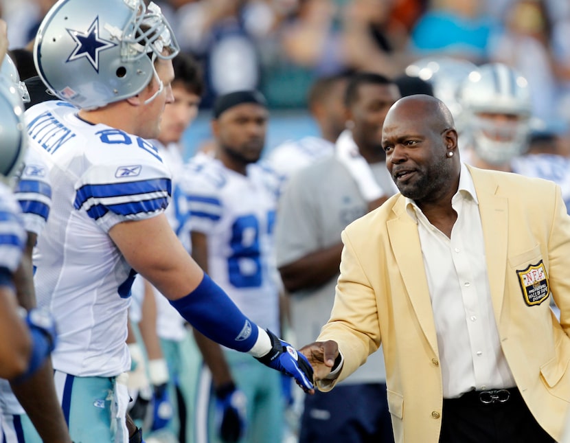 Dallas Cowboys Jason Witten shakes hands with Emmitt Smith before playing a game against the...