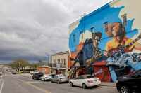 Storm clouds pass over a mural near the Denton Square on Thursday, March 16, 2023 in Denton,...