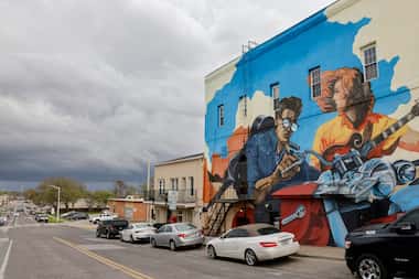Storm clouds pass over a mural near the Denton Square on Thursday, March 16, 2023 in Denton,...