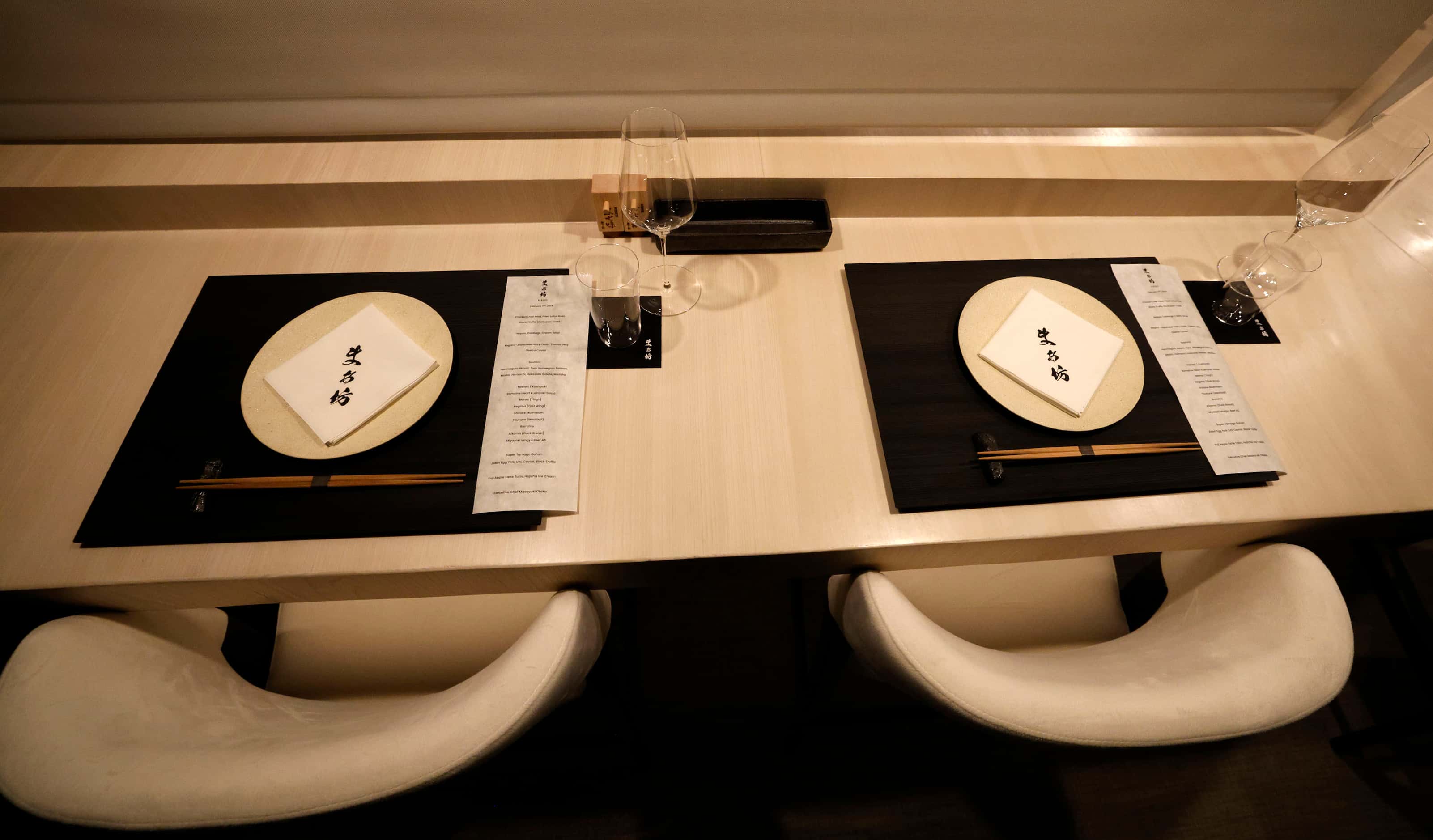 Chopsticks and napkins are set on the counter for customers at Chef Masayuki Otaka’s new...