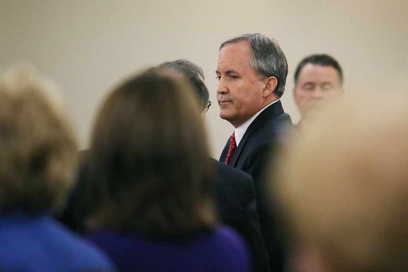Texas Attorney General Ken Paxton speaks with lawyers after he appeared for arraignment in...