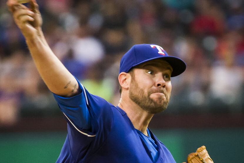 Texas Rangers starting pitcher Colby Lewis pitches during the fourth inning against the Los...