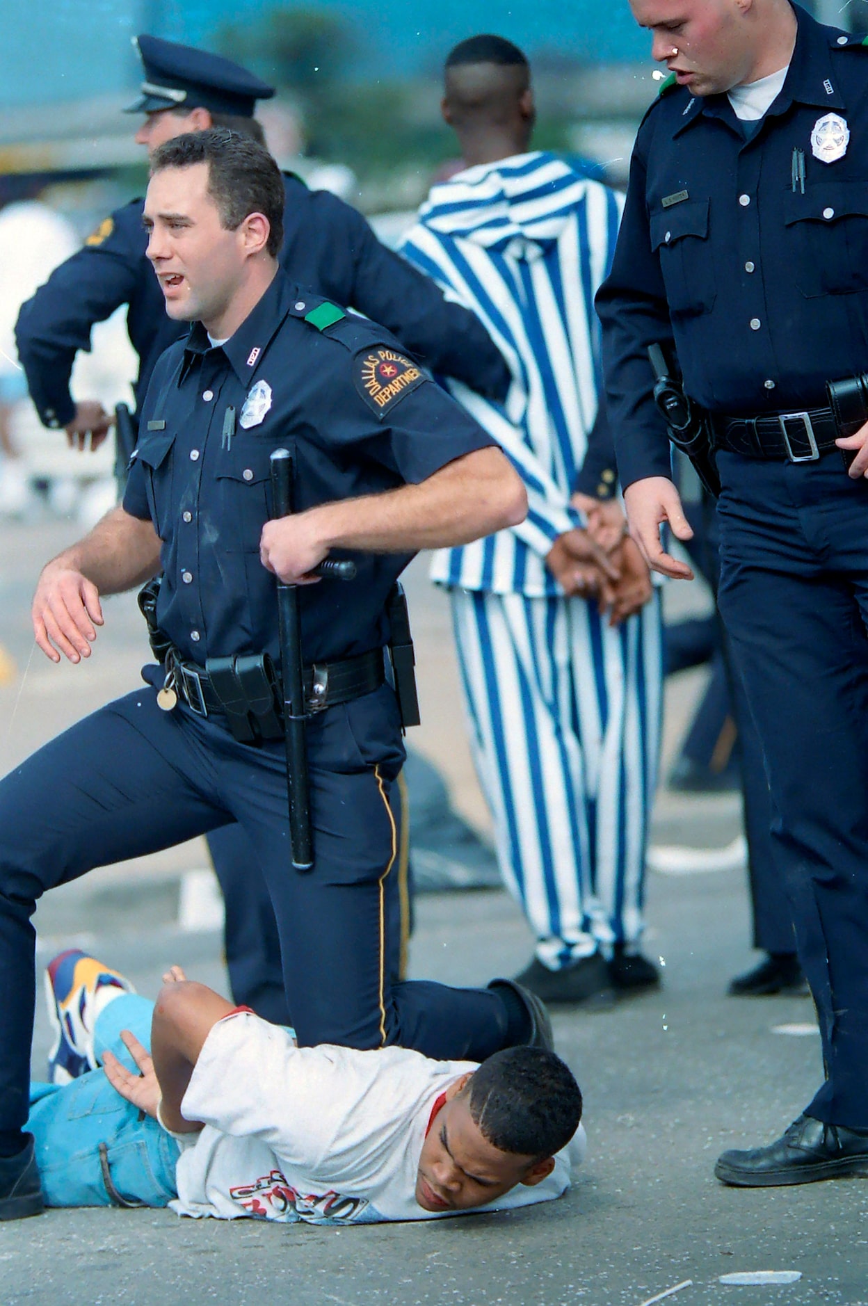 A Dallas Police officer cuffed a teenager after violence erupted along Commerce St following...