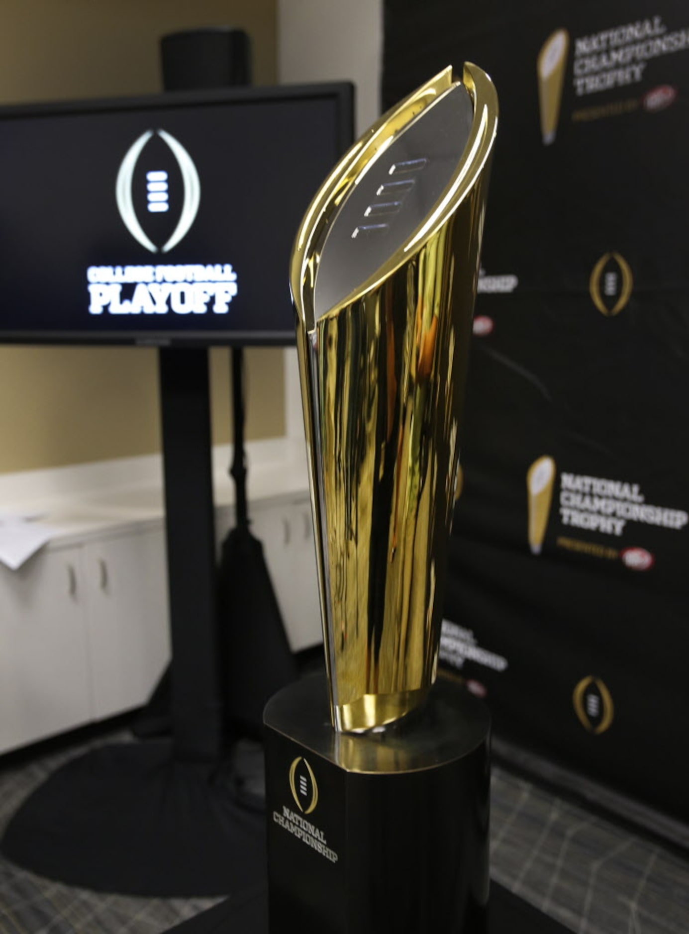 The new national championship trophy for the College Football Playoff is unveiled at a press...