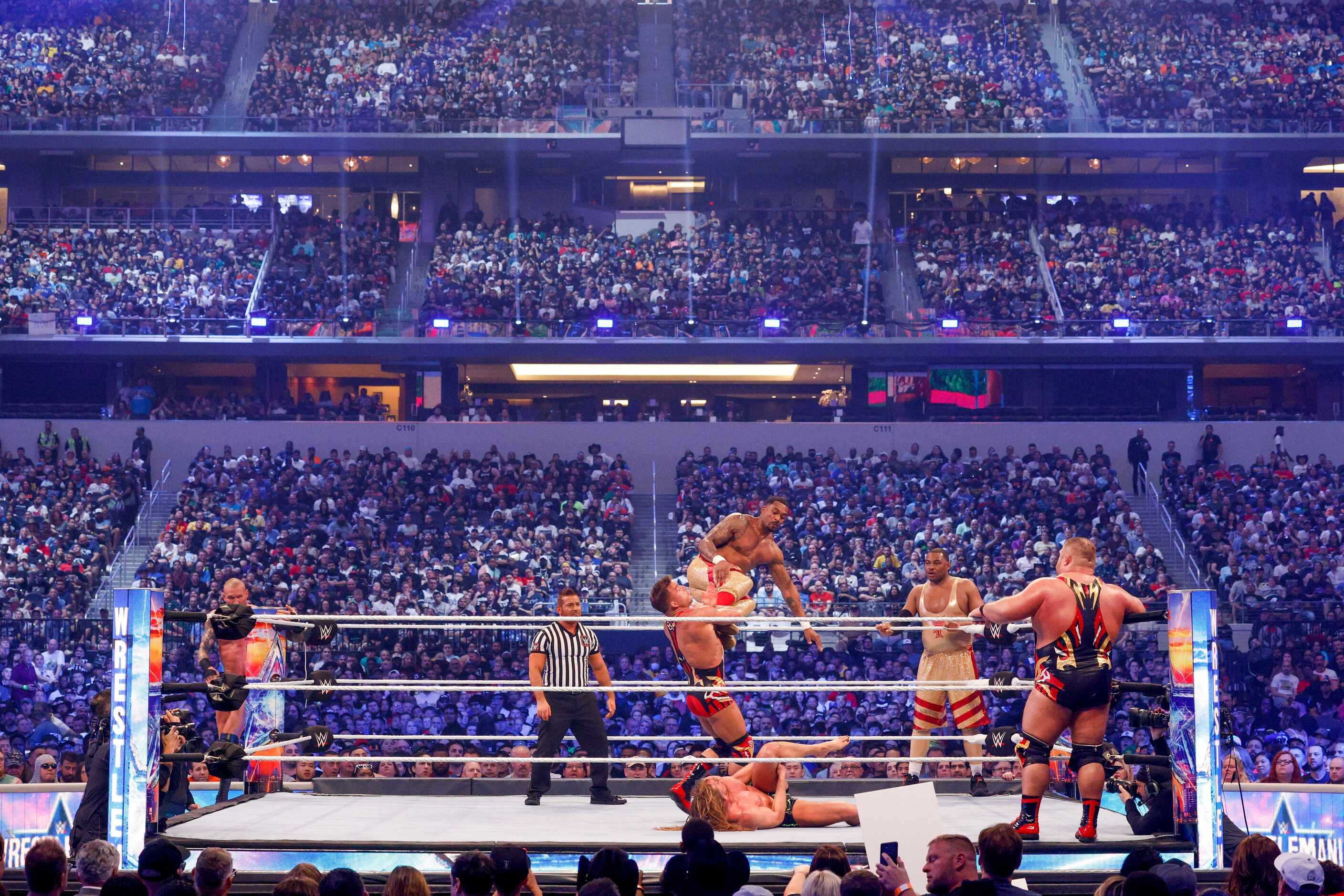 Wrestlers fight during the RAW tag team championship match at WrestleMania Sunday at AT&T...