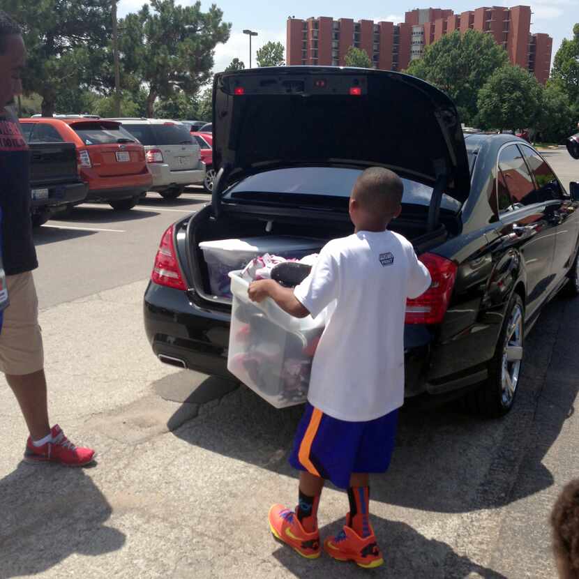 Rowlett resident Jay Fair loads 82 pairs of shoes into his family's car. Fair collected the...