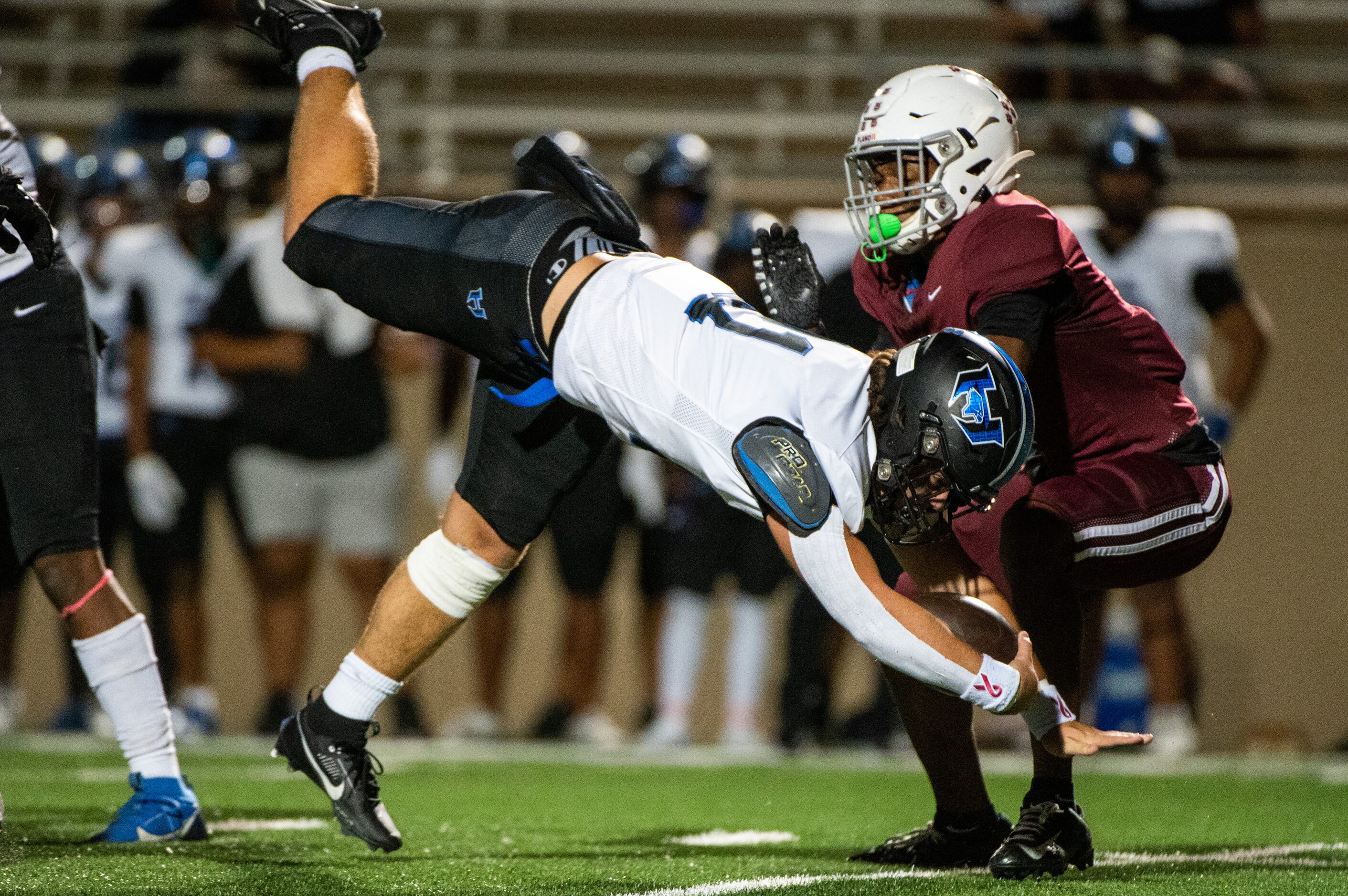 Hebron's Antonio Dennis (21) dives for extra yards in front of Plano's Rohon Kazadi (7) in...